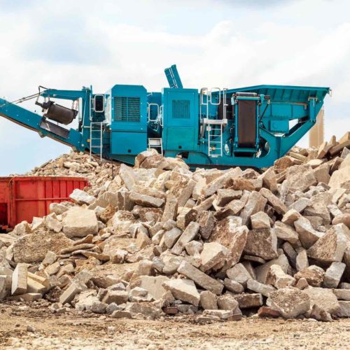 Recycling concrete at a building demolition site.