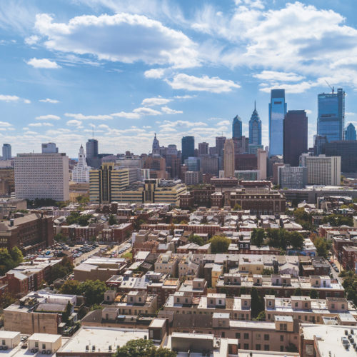 The remote aerial view on Philadelphia Downtown over the residential district of the city. Pennsylvania, USA.The remote aerial view on Philadelphia Downtown over the residential district of the city. Pennsylvania, USA.