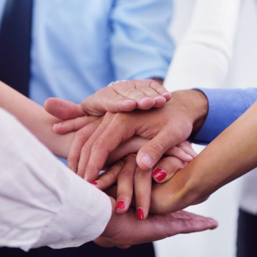 business team joining hands