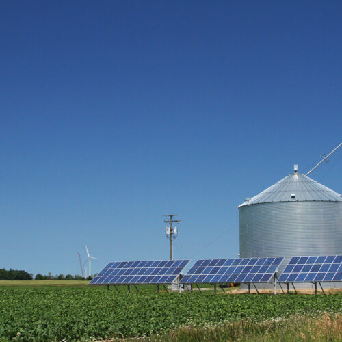 windmill and solar panels on a farm