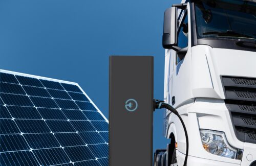 semi-truck charging with solar panel in frame